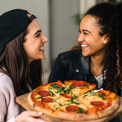 close up hands holding pizza slices