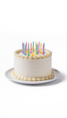 Classic white cream birthday cake with many colorful striped candles on a white plate, isolated on a white background
