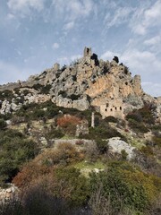 View from below of St. Hilarion Castle rising on the Kyrenia Mountains, highlighting its medieval stone walls and dramatic mountainous setting in northern Cyprus