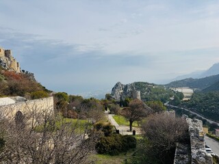 St. Hilarion Castle surrounded by the Kyrenia Mountains in soft morning mist, creating an atmospheric view of the medieval fortress rising above the landscape of northern Cyprus