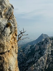 St. Hilarion Castle perched on the rugged Kyrenia Mountains, overlooking the distant coastal city of Kyrenia on Cyprus, with dramatic cliffs, medieval stone walls, and a Mediterranean landscape