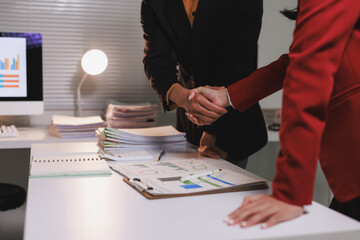 Business professionals shaking hands finalizing agreement in office