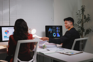 Business colleagues collaborating on data analysis in office