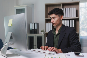 Asian businessman working on computer in modern office