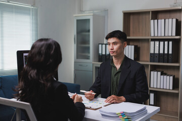 Business colleagues discussing financial strategy during office meeting