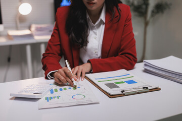 Professional woman analyzing financial data and business reports