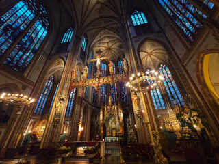 Interior of De Krijtberg, a stunning Neo-Gothic church on the Singel canal, known for its rich, colourful interior, intricate stained glass, and high altar