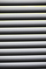 Obraz premium Abstract Close-Up of Closed White Window Blinds with Soft Light Filtering Through
