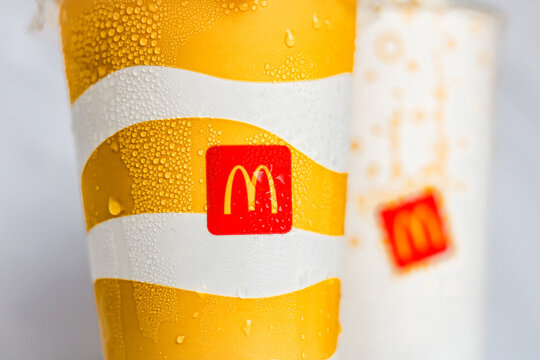 Tangerang, Indonesia - June 16, 2025: Close-up shot of two McDonald's cold drink cups, visible with condensation droplets on their surfaces. 