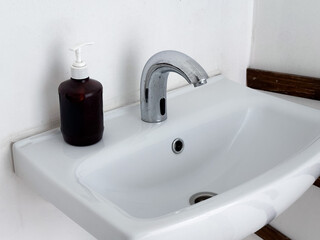 Fototapeta premium Bathroom sink with faucet and soap dispenser.