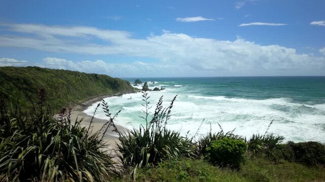 Ocean horizon with choppy surf and coastal scrub foreground