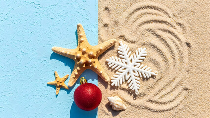Christmas in summer with starfish and snowflake on sandy beach