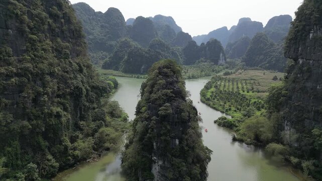 Aerial view of boats along river through karst landscape in Ninh Binh