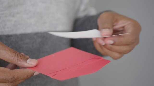 Person holds a thank you card in hands