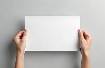 Woman hands hold blank A4 paper sheet for text. Clean white rectangular card isolated on gray background. Empty brochure for advertising or announcement. Presentation template for message.
