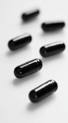 Glossy Black Medical Capsules on White Background Luxury Supplement Concept