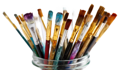 Colorful paint brushes in a glass jar.