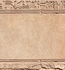 Vertical background with ancient Egyptian hieroglyphs on stone wall, Egypt, Africa. Backdrop with sandstone carving with hieroglyph. Mock up template. Copy space for text