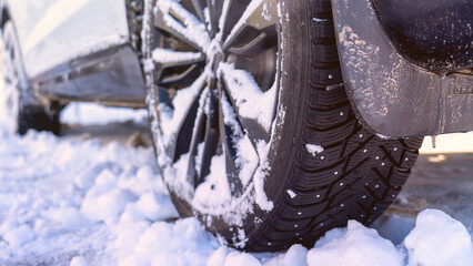 Car tires covered with snow and ice, harsh climatic conditions, operation of vehicles in winter, the condition of winter tires, features of driving in winter conditions, visualization of difficult