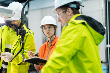 Team of industrial engineer technician discussing technical inspection, maintenance process at modern factory site to ensure operational standards and team coordination.
