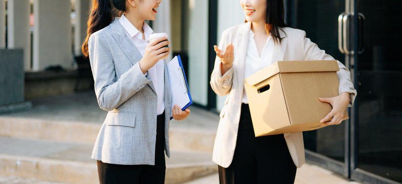 Business women handling delivery box and clipboard at modern office, teamwork, logistics, startup business, professional working lifestyle