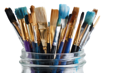 Colorful paint brushes in a glass jar.