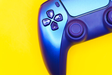 A gamepad for consoles on a yellow background, gaming addiction, gaming ban for teenagers, gaming controls for parents, for banners and advertising. High quality © Karen Vardanian