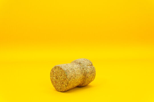 Bottle cork on a yellow background for wine or champagne, cork tree, alcohol and health risks, problems in the family due to alcohol, wine for relaxation. High quality