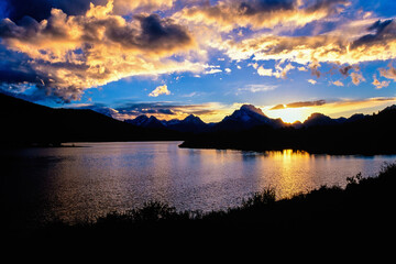 Beautiful sunset by a lake in a mountain landscape