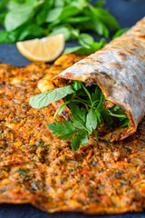 Big size lahmacun on black stone background