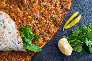 Big size lahmacun on black stone background