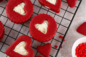 Red velvet sandwich cookies in the shape of a heart with cream cheese filling for Valentines day. Holiday dessert. Copy space.