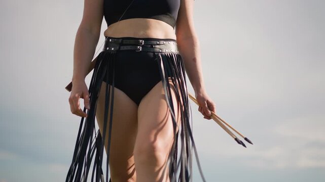 Front view of drummer with fringe skirt and belt, confident stride with drumsticks, parade leader and street performer vibe, sunlit horizon and summer beach backdrop, rhythmic movement and festival