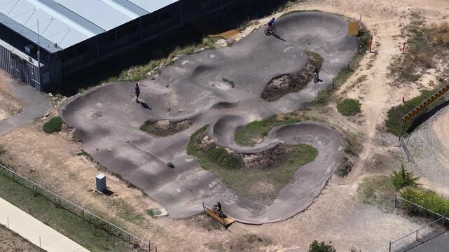 Aerial View of Cyclists Riding on a Modern Asphalt Pump Track
