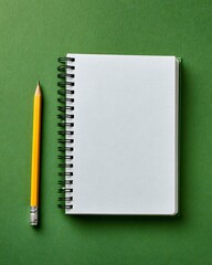 Blank spiral notebook and yellow pencil on green background, flat lay.