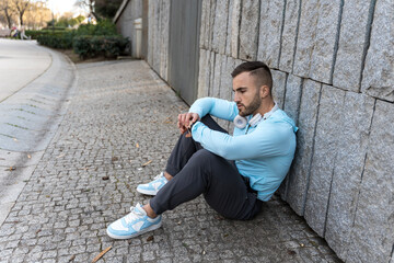 Reflecting quietly by the stone wall in a serene urban park during the late afternoon light