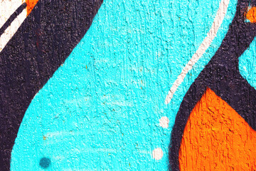 Naklejka premium Abstract graffiti pattern in turquoise, orange, black on textured wall. Urban street art style, bold colors, rough texture. Background, texture, pattern, digital art, creative banner.