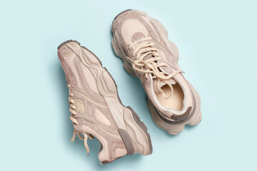 Pair of stylish sneakers on blue background close-up top view © TATIANA KIM