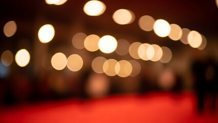 Fototapeta premium Blurred lights and red carpet create a festive and elegant atmosphere.