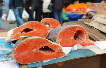 Close-up of fresh salmon steaks on a stall at an open market