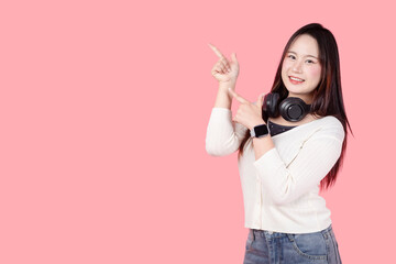 Portrait Asian teenage woman standing happy smile studio shot isolated, hand pointing.