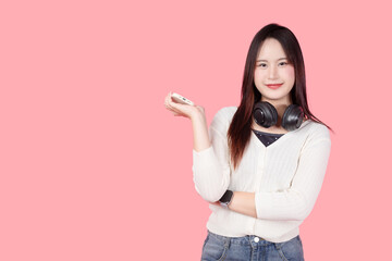 young teen girl happy smile enjoy music from phone, listening music by headphone studio isolated