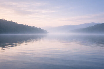 Fototapeta premium Calm Misty Lake With Soft Reflections And Copy Space