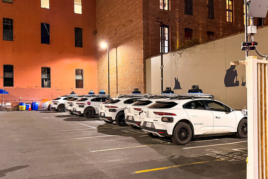 Waymo self-driving cars charging at a parking lot in San Francisco, California