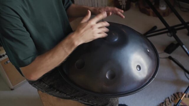 Playing a handpan in a cozy room with natural light