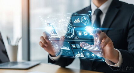 Businessperson holding a transparent digital interface displaying data analytics and business metrics