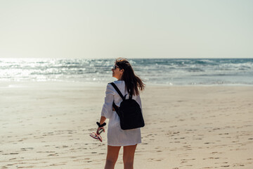 Woman walking with flip flops on Sotavento beach, Fuerteventura