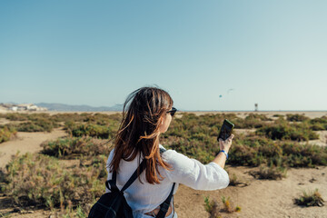 Caucasian woman taking a selfie in arid landscape, Fuerteventura