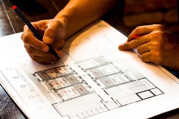 Architect working on building house plans