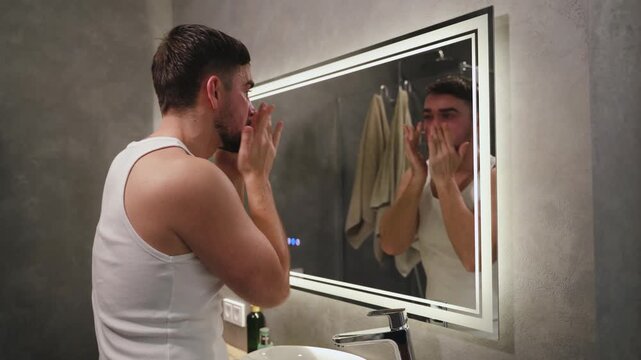 Man Applying Moisturizer to Face After Washing